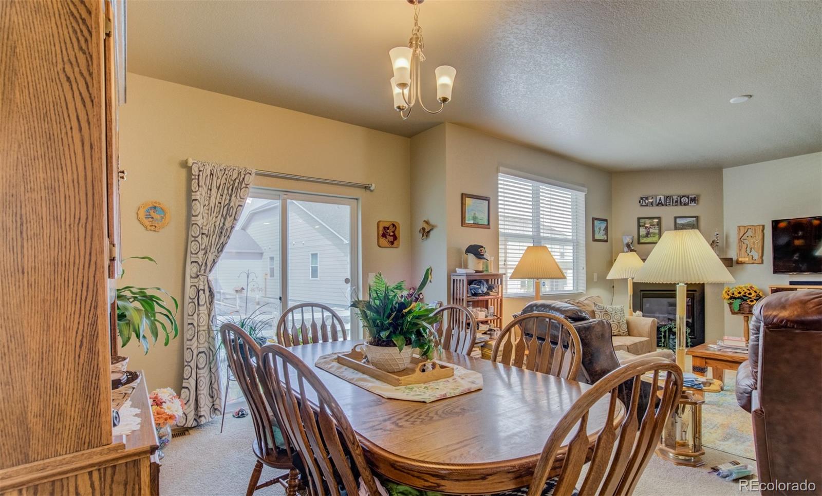 5907 Point Rider Circle Castle Rock, CO 80104 - Photo 8 of 29 a view of a dining room with furniture window and wooden floor