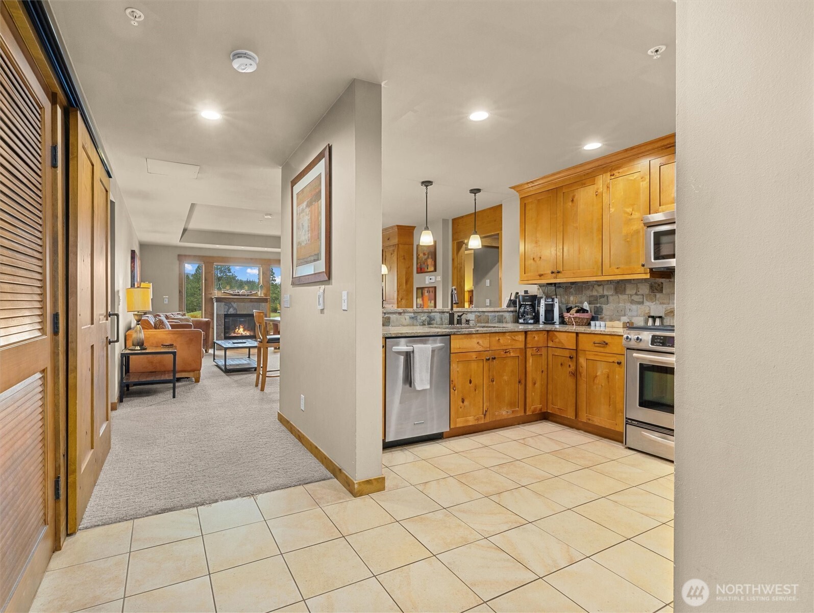 3770 Suncadia Trail, Unit 102 Cle Elum, WA 98922 - Photo 3 of 35 a kitchen with a sink a counter top space stainless steel appliances cabinets and a window