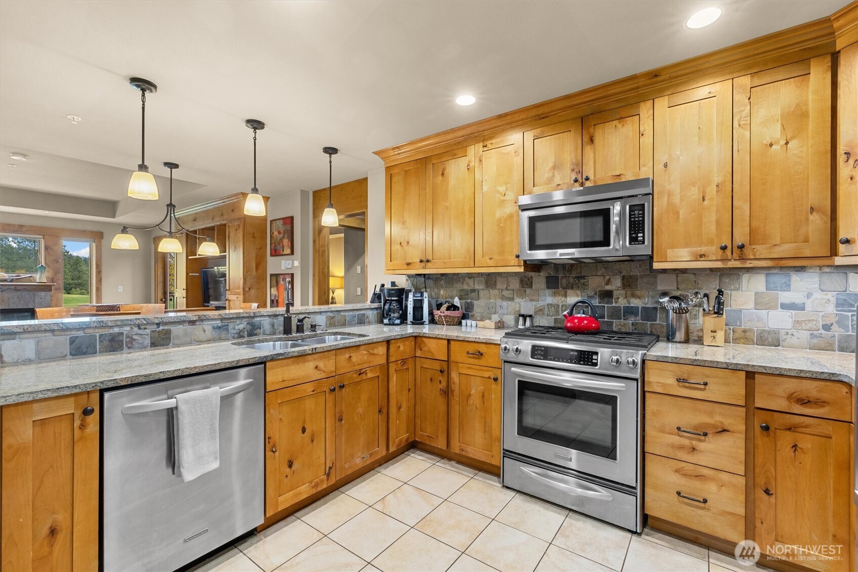 3770 Suncadia Trail, Unit 102 Cle Elum, WA 98922 - Photo 4 of 35 a kitchen with stainless steel appliances granite countertop a stove sink microwave and cabinets