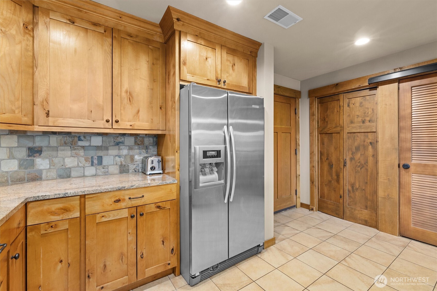 3770 Suncadia Trail, Unit 102 Cle Elum, WA 98922 - Photo 7 of 35 a kitchen with stainless steel appliances granite countertop a refrigerator and a stove top oven