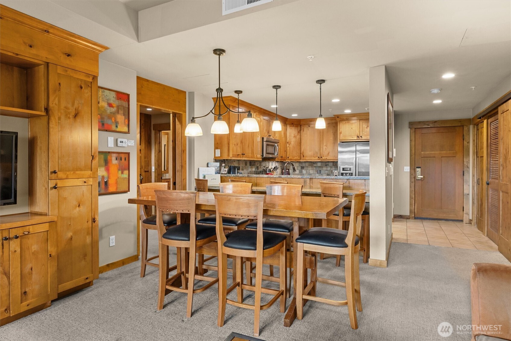 3770 Suncadia Trail, Unit 102 Cle Elum, WA 98922 - Photo 10 of 35 a dining area with a table chairs and a kitchen view