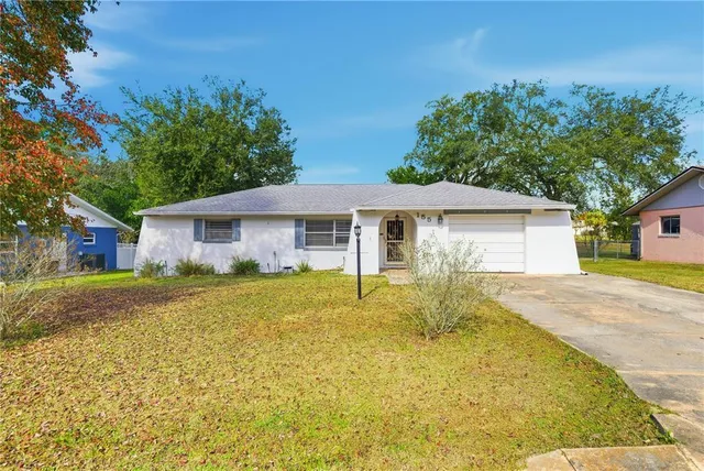 a front view of house with yard and green space