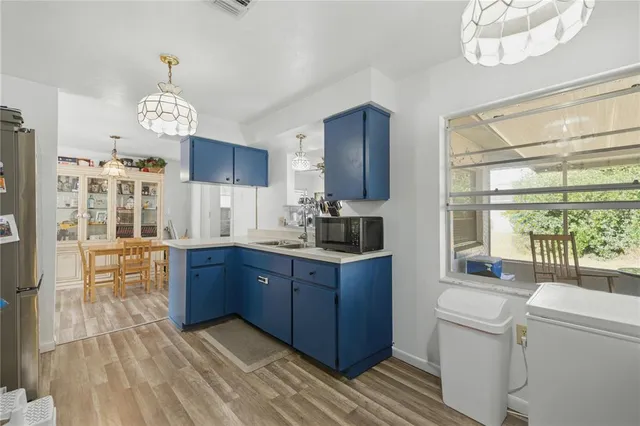 a kitchen with granite countertop a stove cabinets and wooden floor