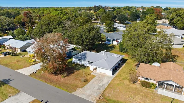 an aerial view of a house with a yard