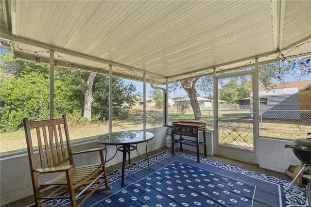a view of a room with furniture large windows and wooden floor