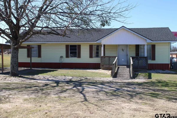 a house that has a tree in front of it