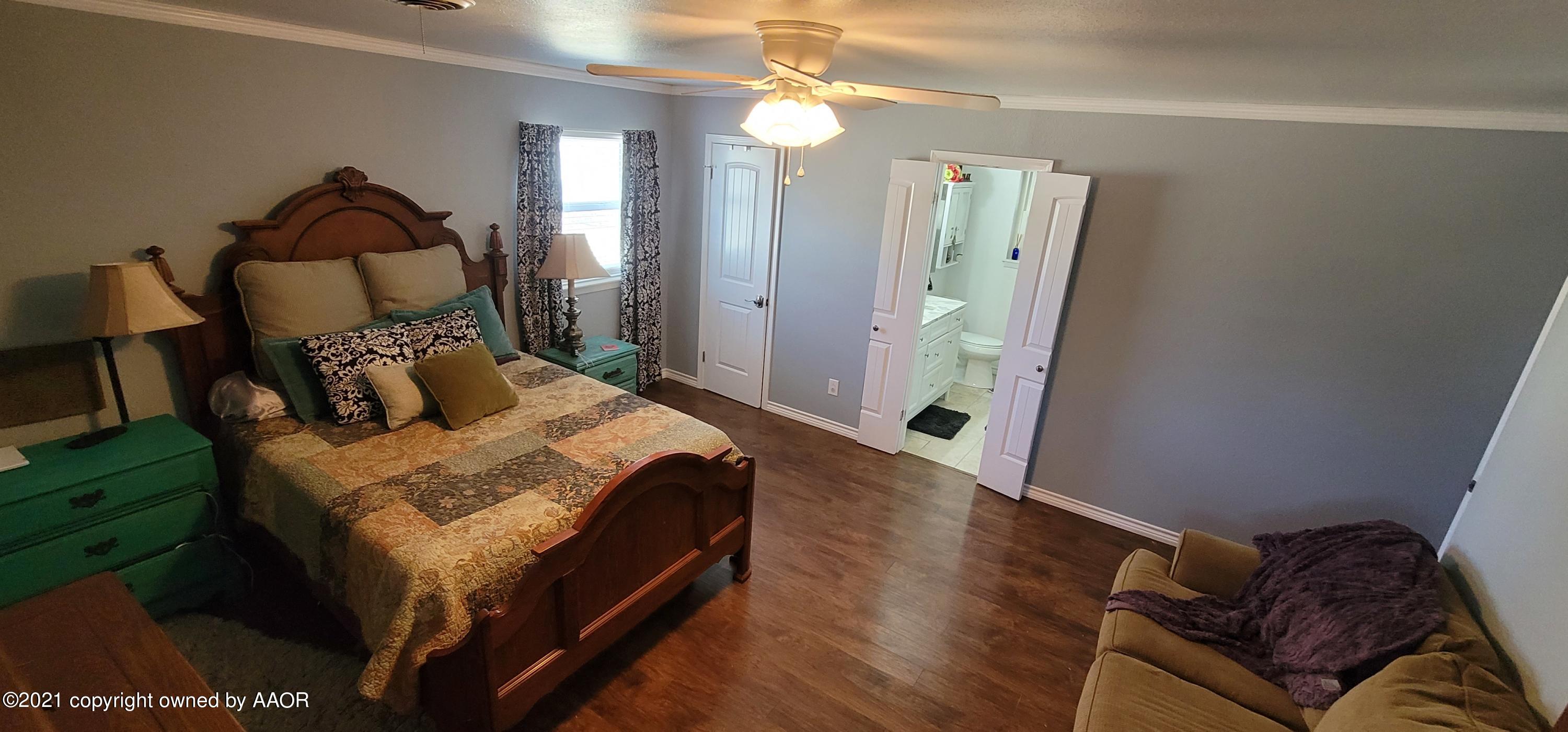 6004 Calumet Road Amarillo, TX 79106 - Photo 19 of 33 a bed sitting in a bedroom next to a window