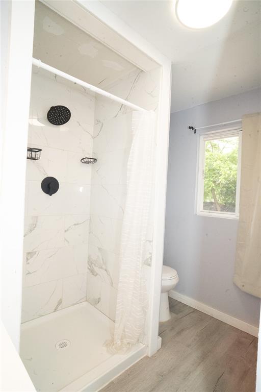 2136 Ridgeway Street Arlington, TX 76010 - Photo 21 of 32 a bathroom with a shower and a toilet