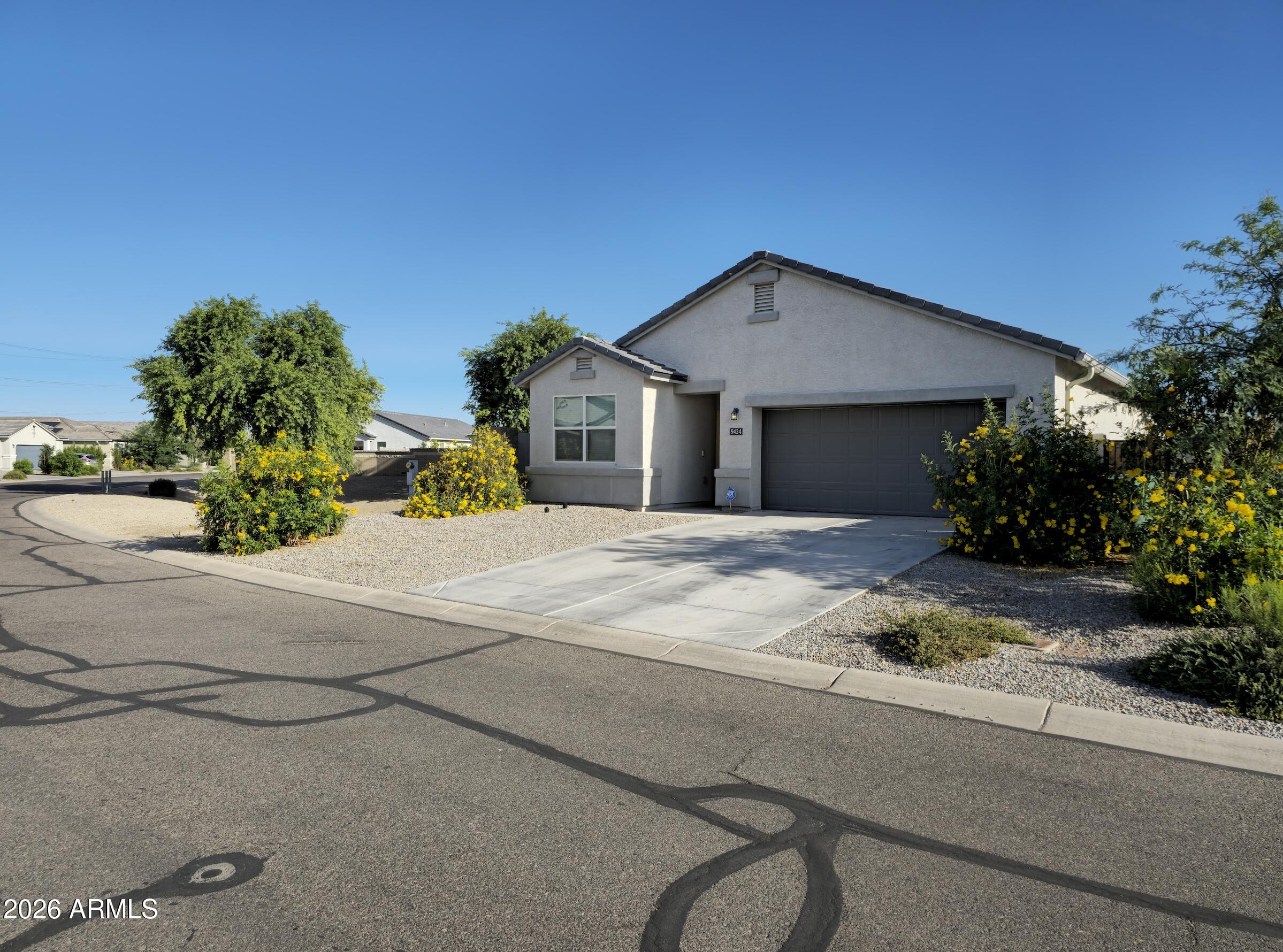 9434 Cotton Road Florence, AZ 85132 - Photo 2 of 25 a front view of a house with a yard and garage