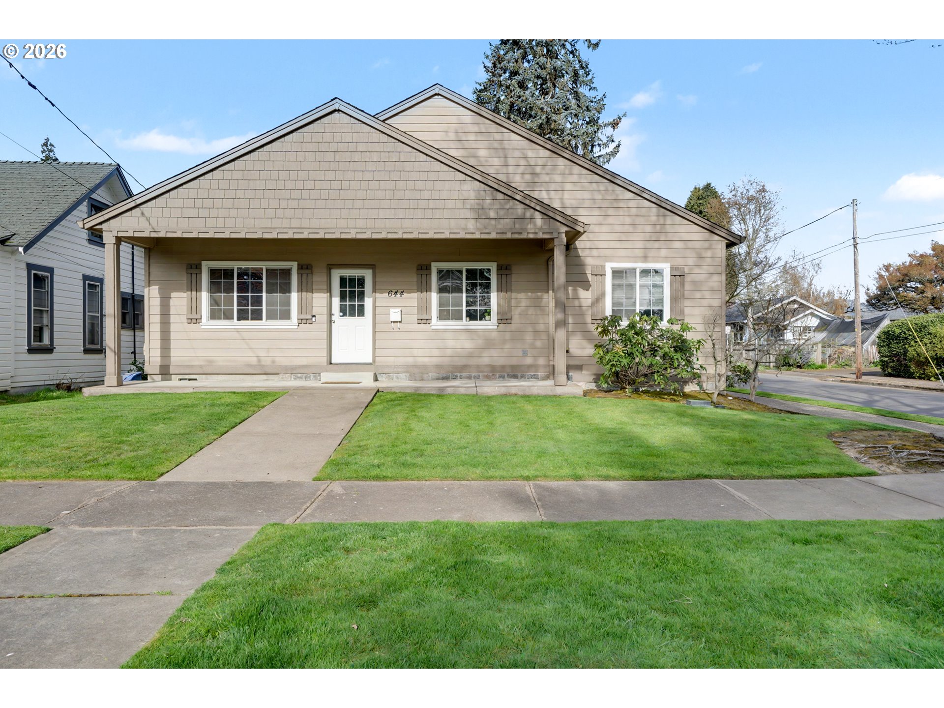 644 Northwest 14th Street Corvallis, OR 97330 - Photo 1 of 23 a front view of a house with a yard and garage