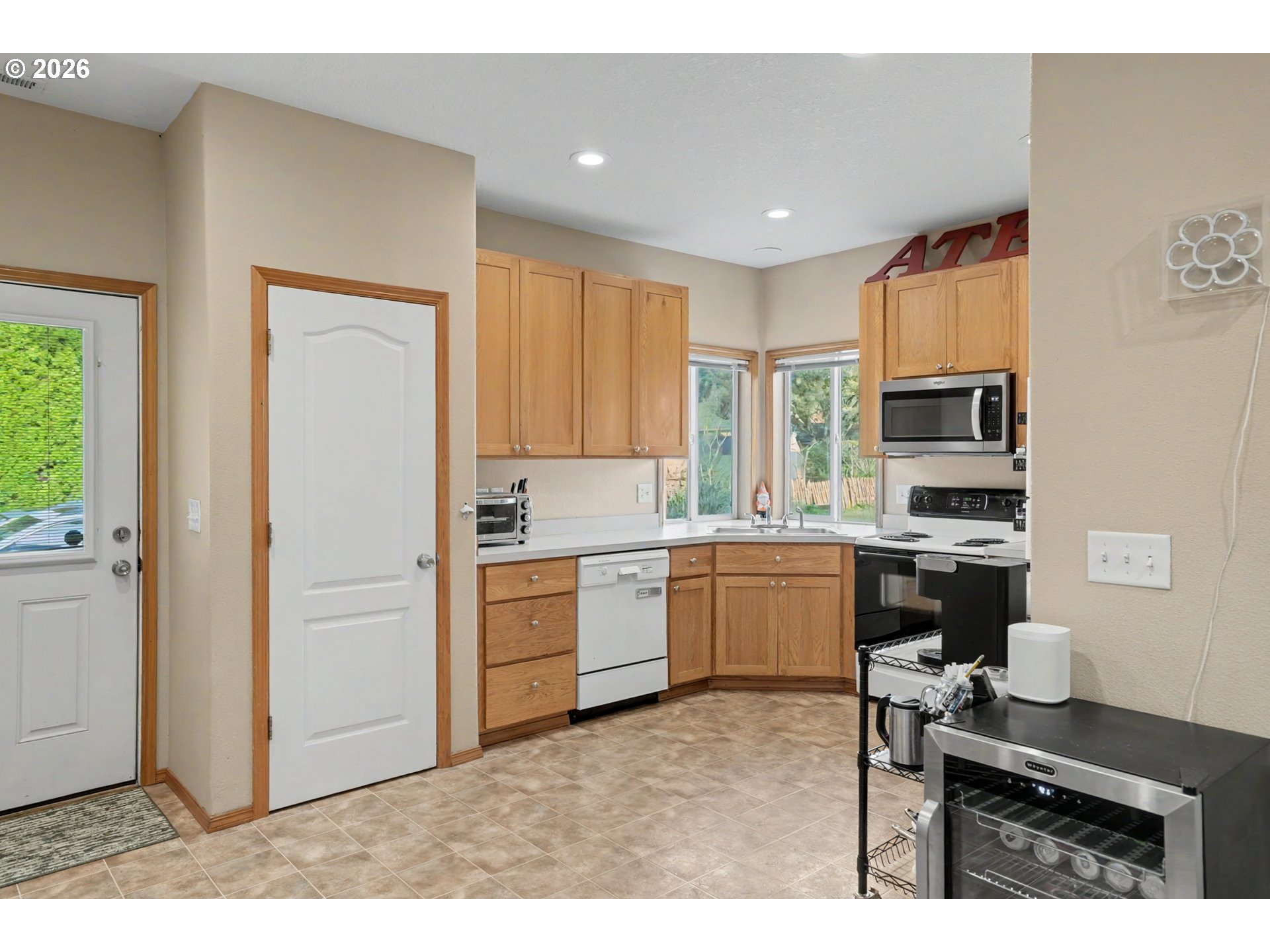 644 Northwest 14th Street Corvallis, OR 97330 - Photo 19 of 23 a kitchen with a refrigerator and a stove top oven