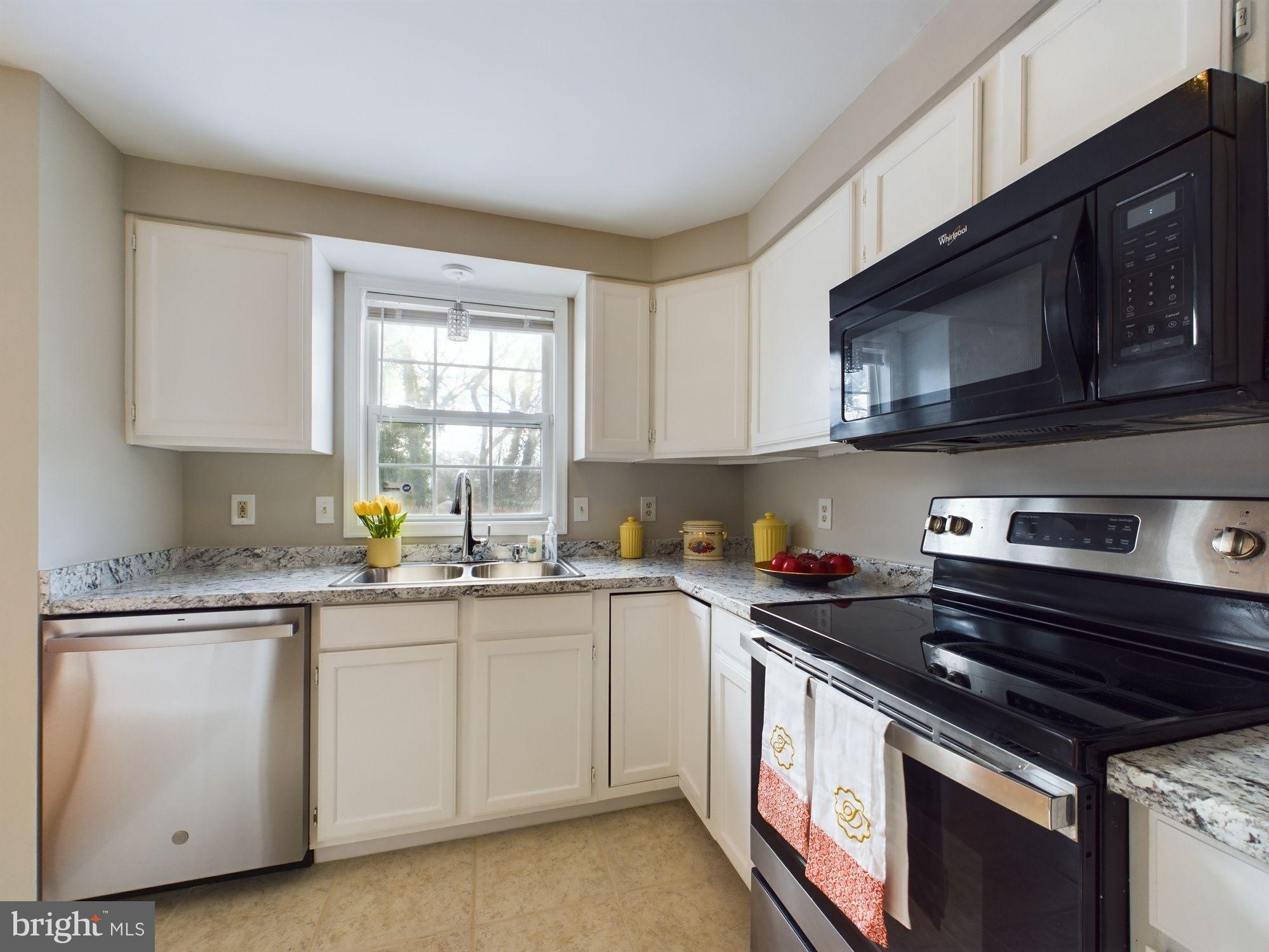 4433 Hunt Place Northeast Washington, DC 20019 - Photo 11 of 25 a kitchen with stainless steel appliances granite countertop a sink a stove and cabinets