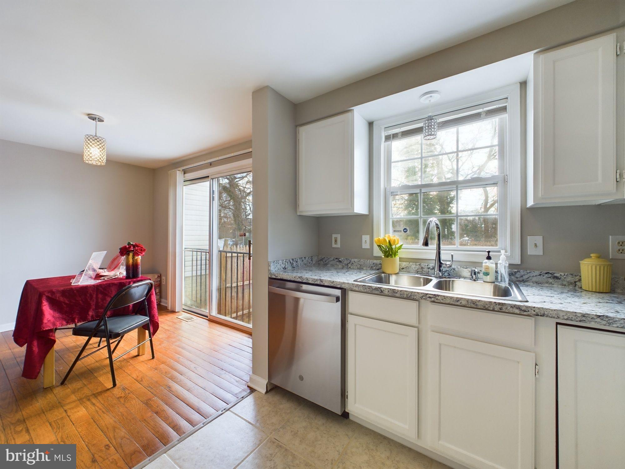 4433 Hunt Place Northeast Washington, DC 20019 - Photo 12 of 25 a kitchen with granite countertop a sink cabinets and wooden floor