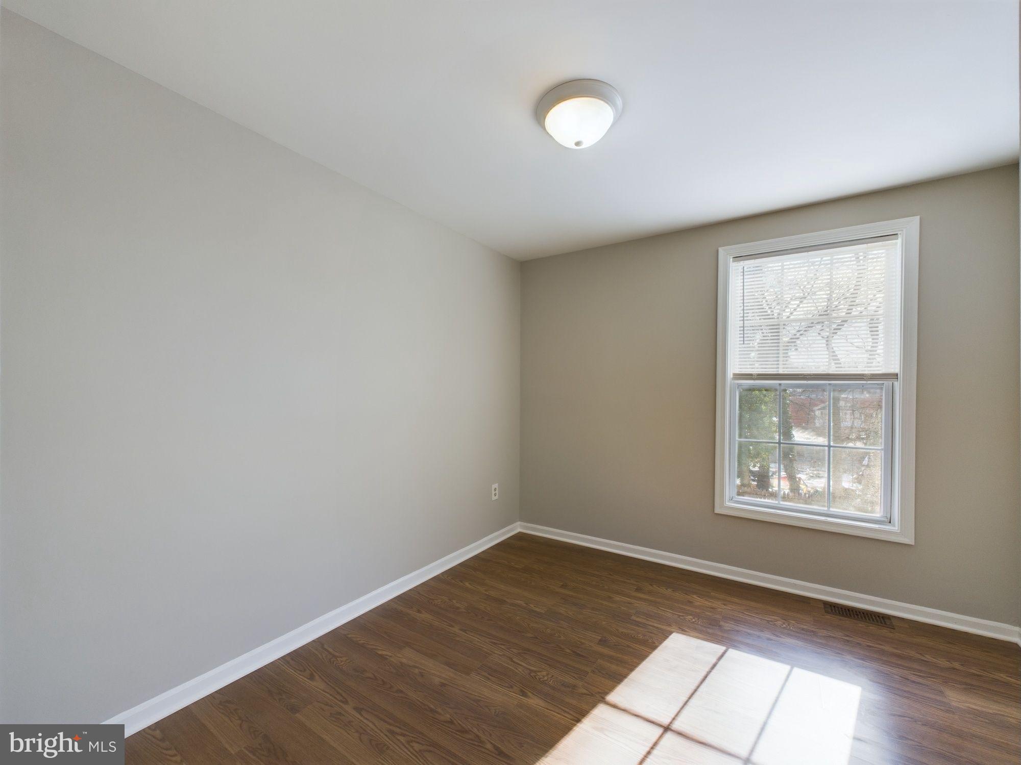 4433 Hunt Place Northeast Washington, DC 20019 - Photo 16 of 25 an empty room with wooden floor and windows