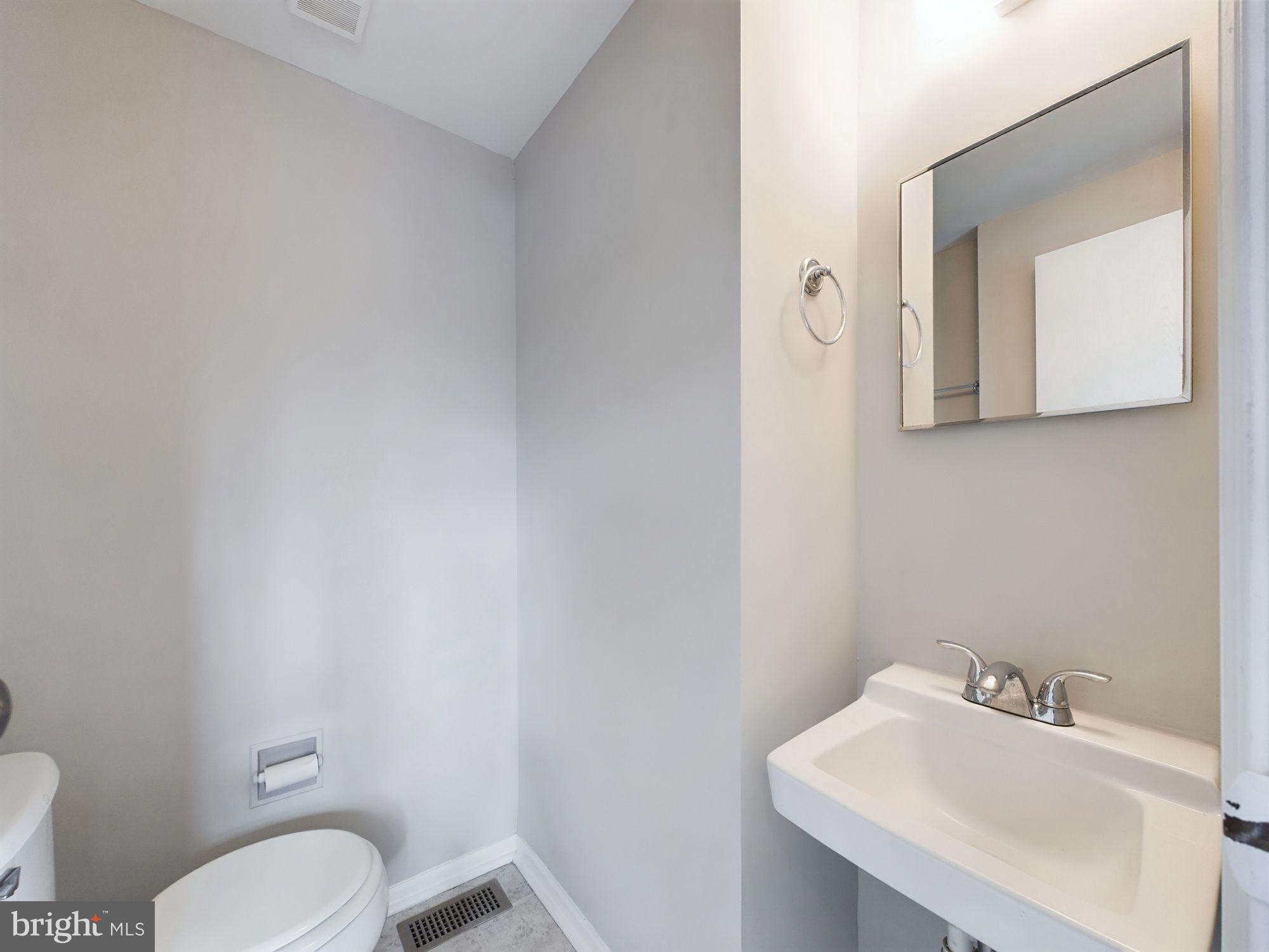 4433 Hunt Place Northeast Washington, DC 20019 - Photo 8 of 25 a bathroom with a toilet sink and mirror