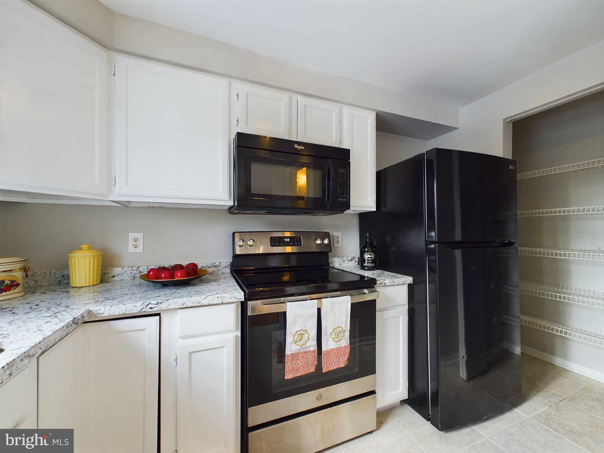 4433 Hunt Place Northeast Washington, DC 20019 - Photo 10 of 25 a kitchen with stainless steel appliances granite countertop a stove a refrigerator and a cabinets