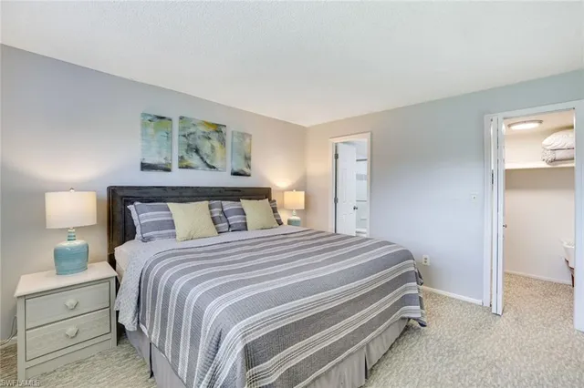 a bedroom with a bed and a lamp on table