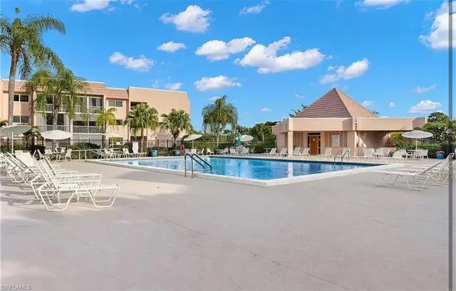 a swimming pool with outdoor seating and yard