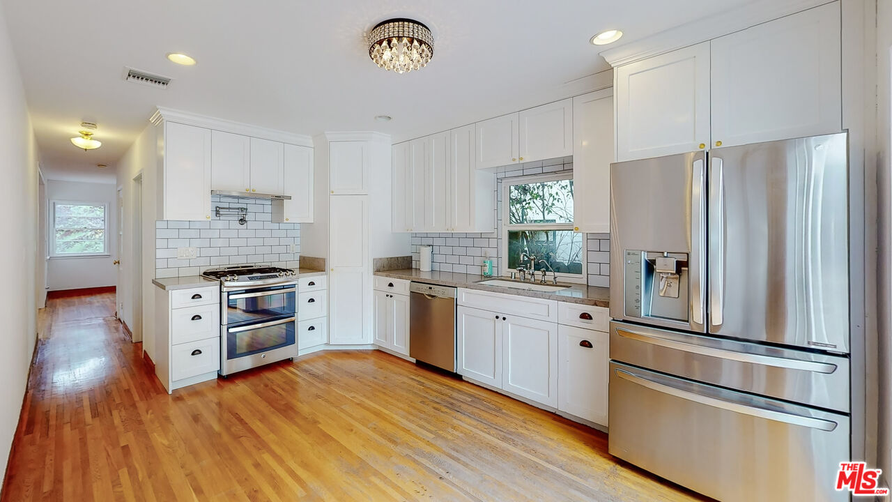 365 Sycamore Road Santa Monica, CA 90402 - Photo 11 of 42 a kitchen with stainless steel appliances a refrigerator and a stove
