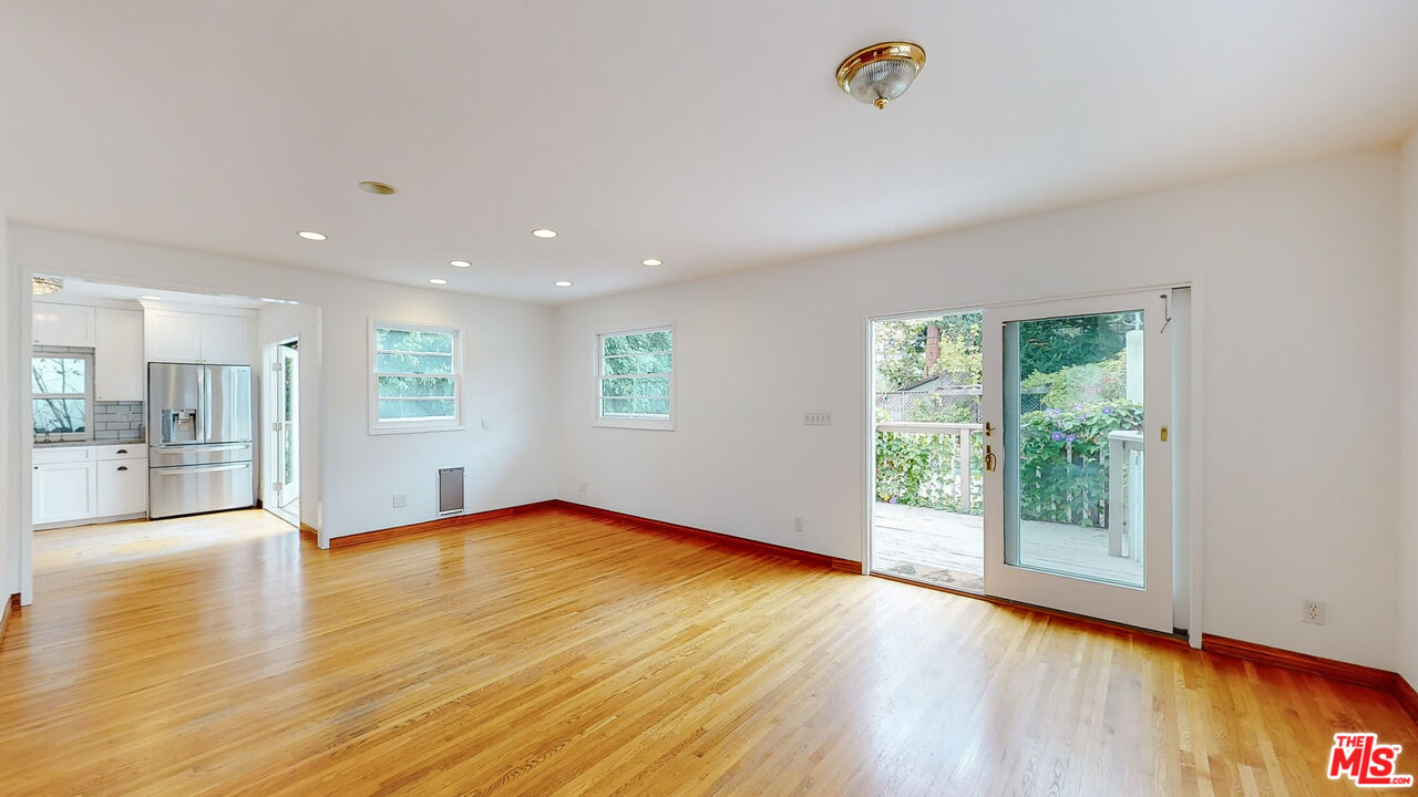 365 Sycamore Road Santa Monica, CA 90402 - Photo 13 of 42 a view of an empty room with wooden floor and a window