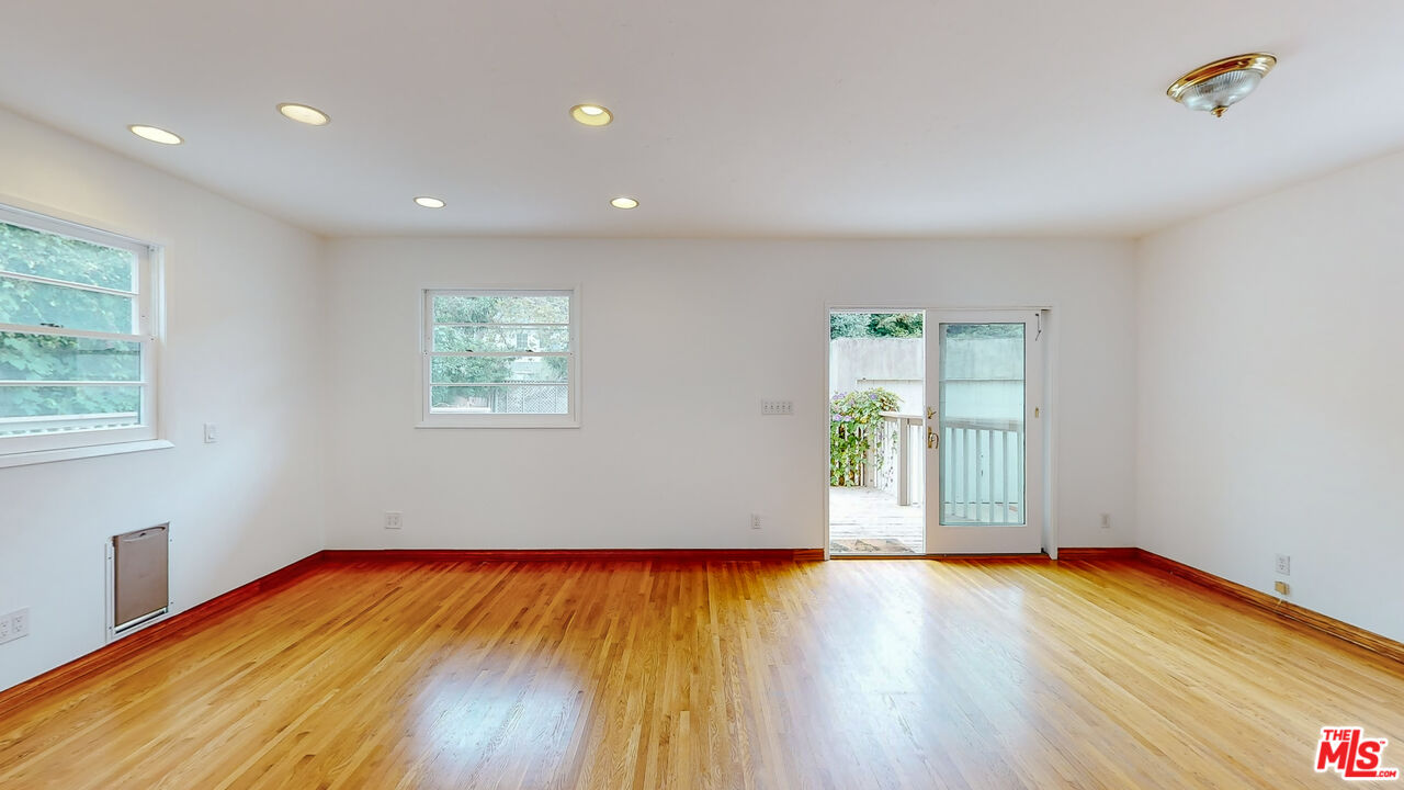 365 Sycamore Road Santa Monica, CA 90402 - Photo 14 of 42 a view of empty room with wooden floor and fan