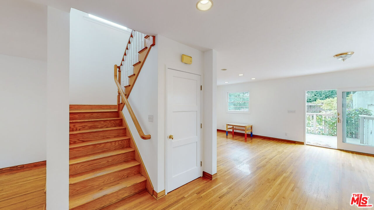 365 Sycamore Road Santa Monica, CA 90402 - Photo 16 of 42 a view of an entryway with wooden floor staircase and a living room