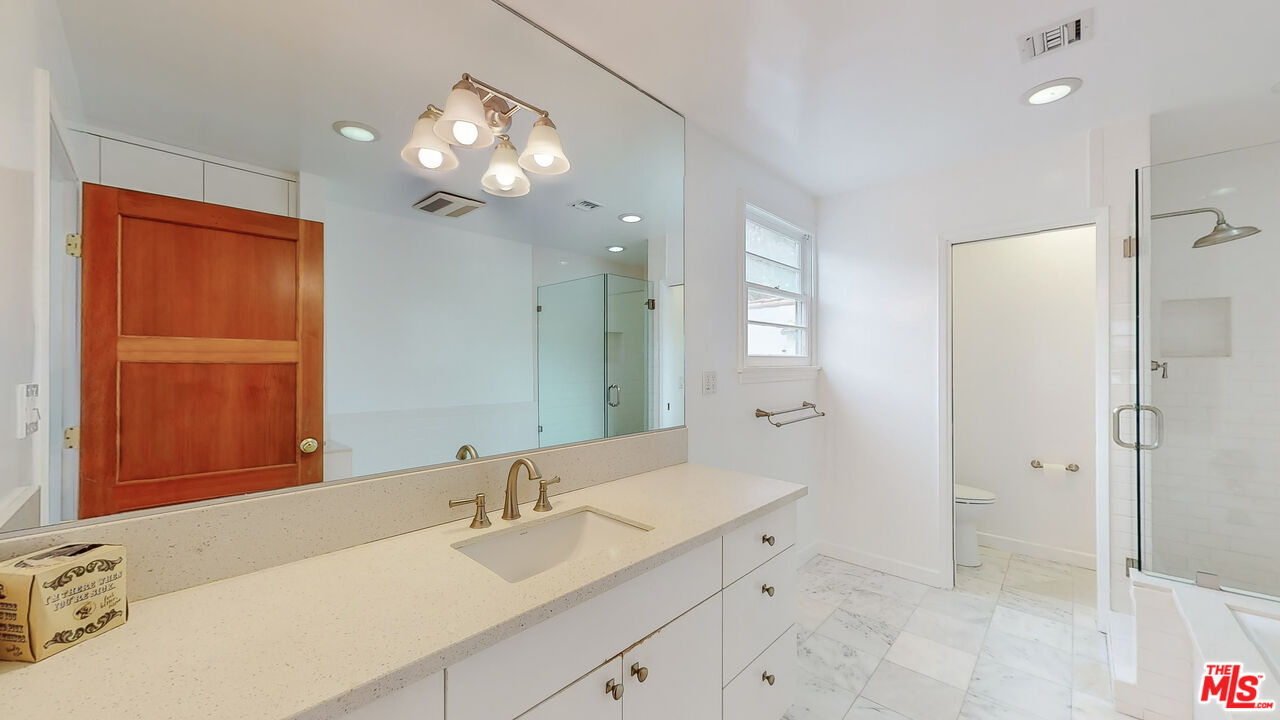 365 Sycamore Road Santa Monica, CA 90402 - Photo 19 of 42 a bathroom with a sink a light fixture and a mirror