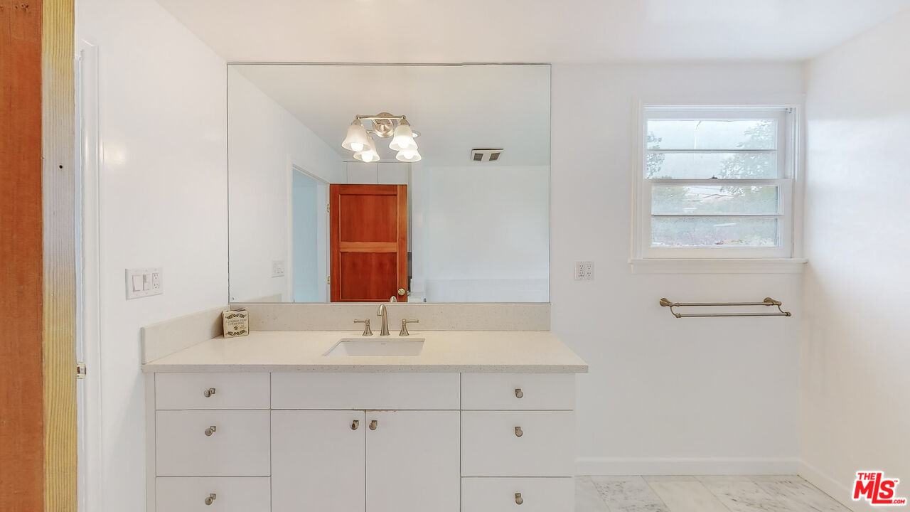 365 Sycamore Road Santa Monica, CA 90402 - Photo 20 of 42 a bathroom with a sink and a mirror