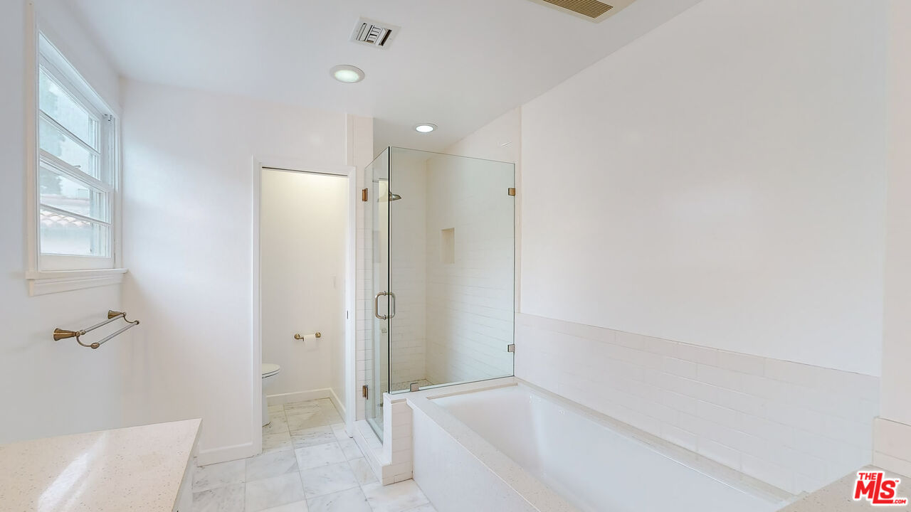 365 Sycamore Road Santa Monica, CA 90402 - Photo 21 of 42 a bathroom with a shower and a glass door