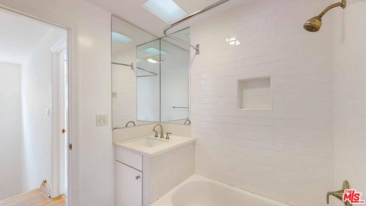 365 Sycamore Road Santa Monica, CA 90402 - Photo 28 of 42 a bathroom with a bathtub a shower a sink and mirror