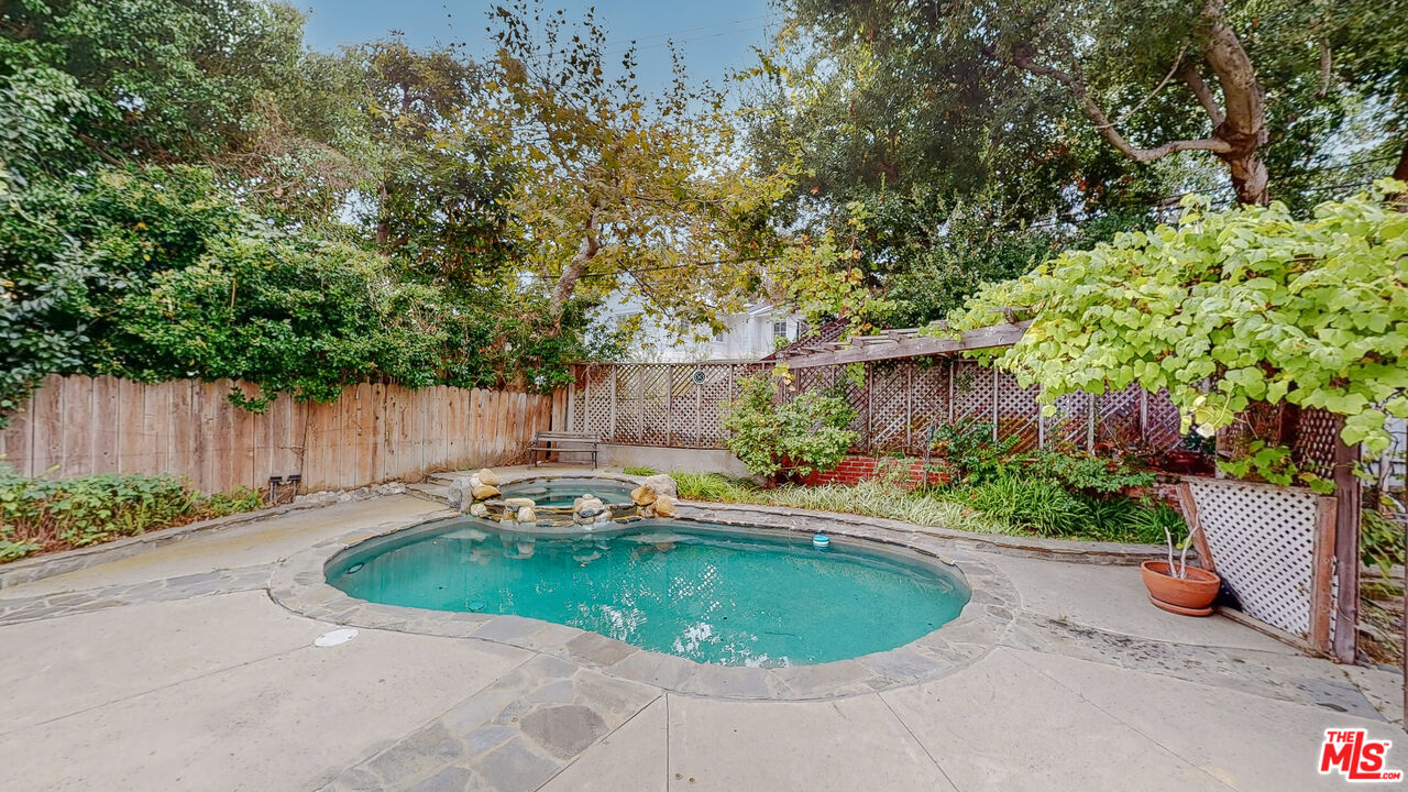 365 Sycamore Road Santa Monica, CA 90402 - Photo 35 of 42 a small pool with outdoor seating and garden
