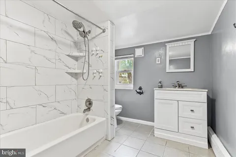 a bathroom with a bathtub a sink a toilet and a mirror