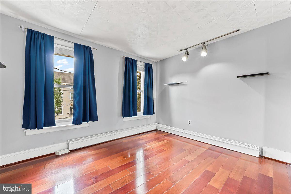 318 East 6th Avenue Conshohocken, PA 19428 - Photo 14 of 17 a view of an empty room with wooden floor and a window