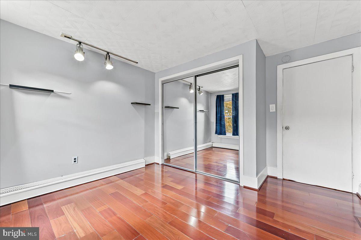 318 East 6th Avenue Conshohocken, PA 19428 - Photo 15 of 17 a view of empty room with wooden floor and fan