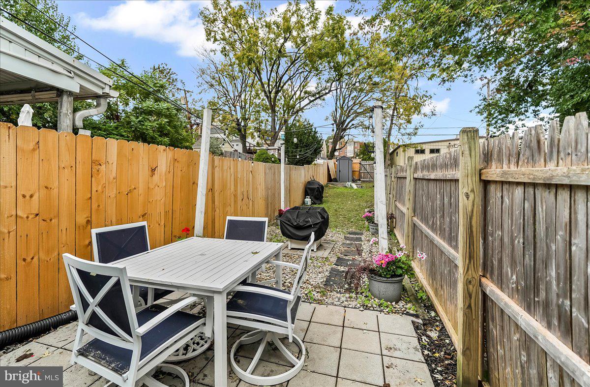 318 East 6th Avenue Conshohocken, PA 19428 - Photo 16 of 17 a view of a patio with table and chairs with wooden fence and floor