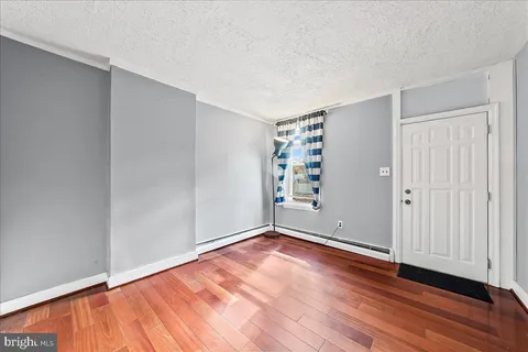 wooden floor in an empty room with a window
