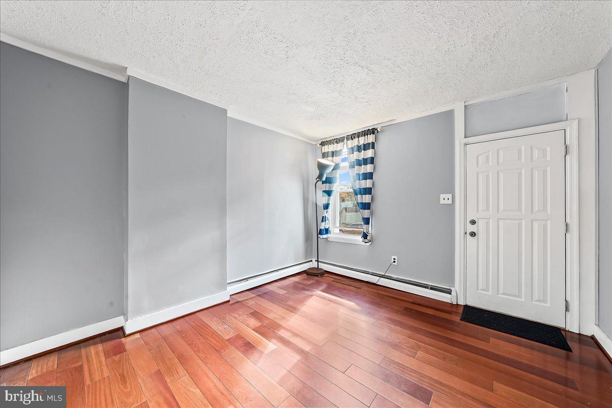 318 East 6th Avenue Conshohocken, PA 19428 - Photo 4 of 17 wooden floor in an empty room with a window