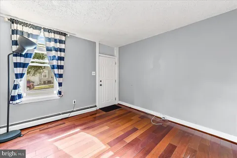 a view of room with window and hardwood floor