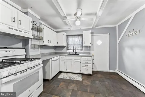 a kitchen with stainless steel appliances granite countertop a sink and cabinets