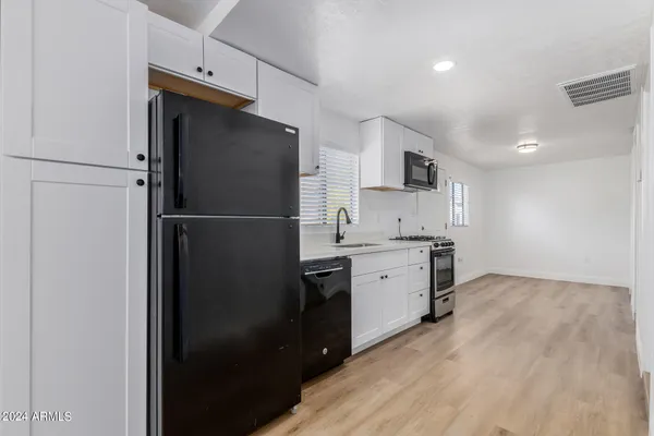 a kitchen with a refrigerator and a sink