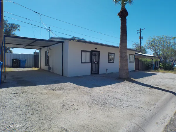 a view of a house with a backyard and garage