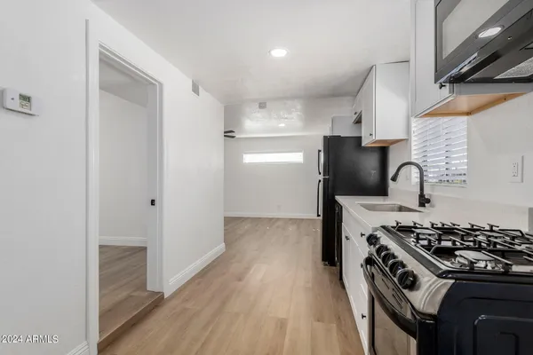 a kitchen with a stove and a refrigerator