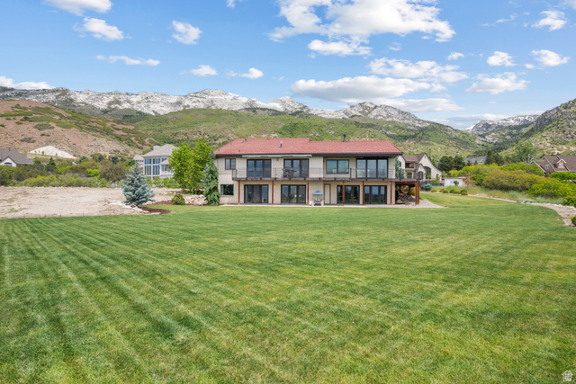 4221 Juniper Circle Alpine, UT 84004 - Photo 46 of 66 Expansive rear lawn featuring a two-story residence with multiple balconies and patio access