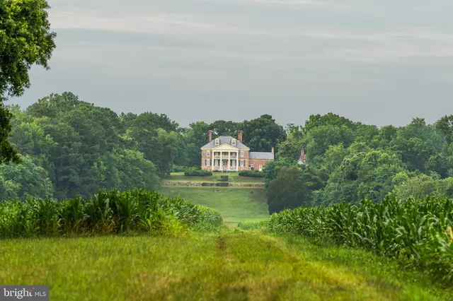 a view of a dining room with furniture and windows