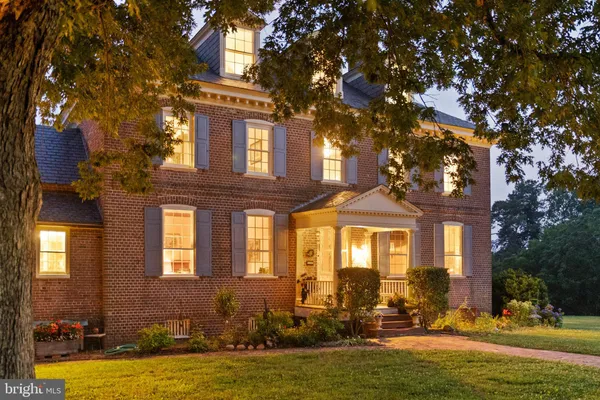 a front view of a house with outdoor seating