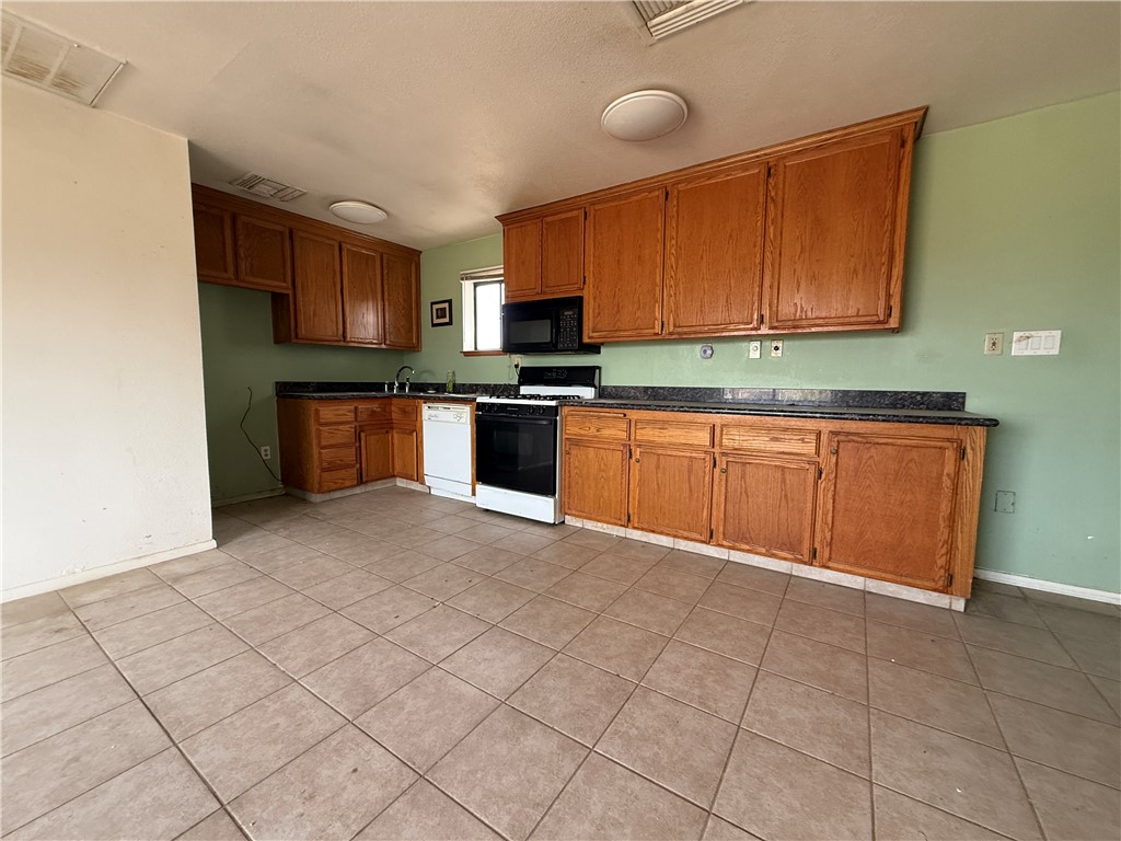 3443 3rd Street Inyokern, CA 93527 - Photo 12 of 25 a kitchen with stainless steel appliances granite countertop a sink stove and cabinets