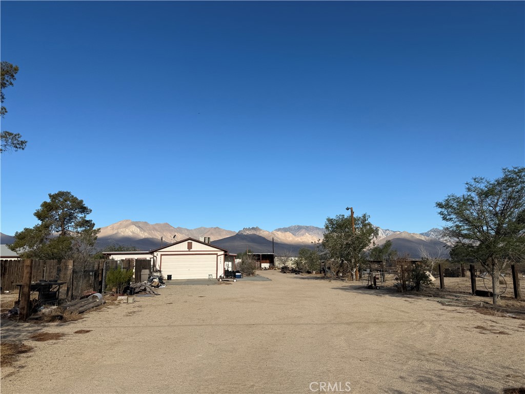 3443 3rd Street Inyokern, CA 93527 - Photo 2 of 25 a front view of a house with a yard and garage