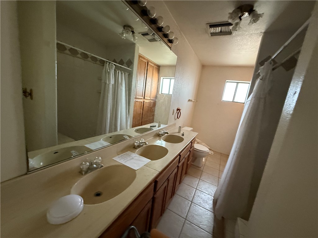 3443 3rd Street Inyokern, CA 93527 - Photo 21 of 25 a bathroom with a sink and mirror with toilet