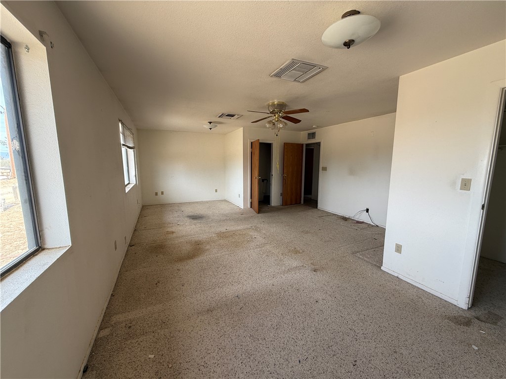 3443 3rd Street Inyokern, CA 93527 - Photo 23 of 25 en empty room with windows and ceiling fan