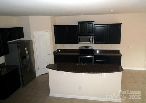 1003 Blue Stream Lane Indian Trail, NC 28079 - Photo 3 of 18 a kitchen with a refrigerator and microwave